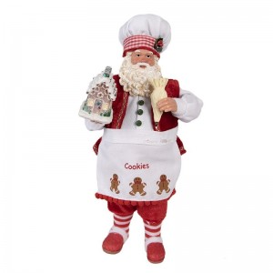 Vianočná dekorácia plastového Mikuláša cukrára v textilnom vianočnom oblečení so zásterou a medovníkovým domčekom 16 x 8 x 28 cm Clayre & Eef 42416