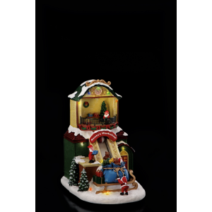 Vianočná dekorácia polyresinovej scénky Santovej dielne s elfami, darčekmi a LED osvetlením 19 x 15 x 23,5 cm 41900